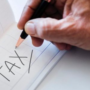 photo of hand and the word tax
